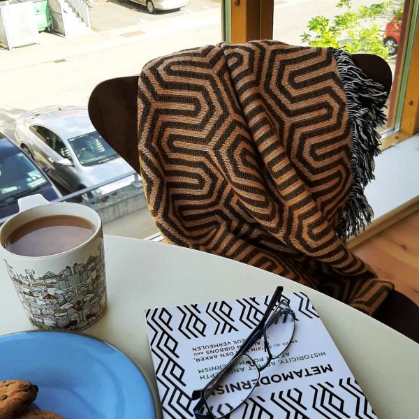 A shot of the Kinhexic Orange & Chocolate colour throw draped over an Arne Jacobsen chair