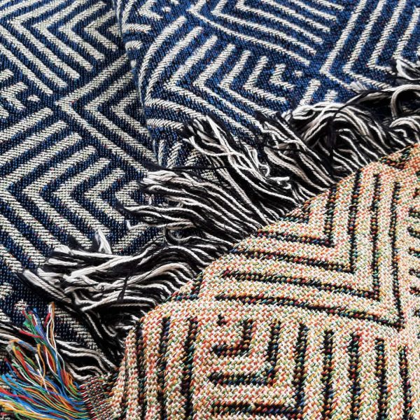 A close-up shot of the Misty Mountain Throw folded to show the colour of both sides of the design