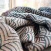 Close-up view of the Shrouded Sea throw casually lying on furniture